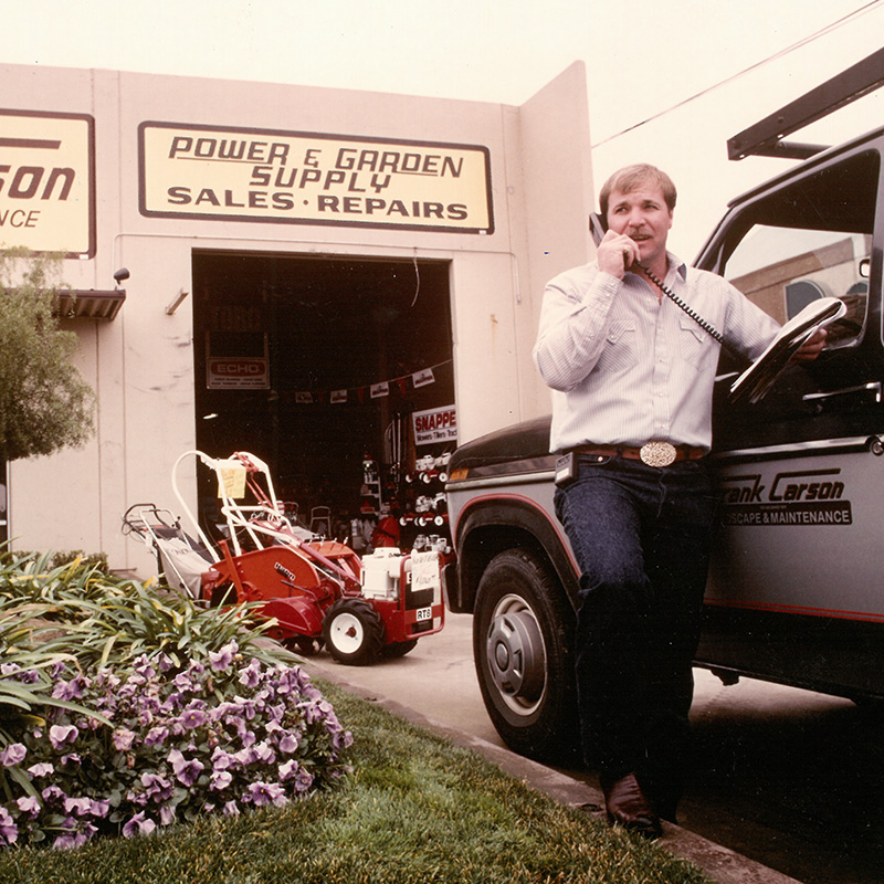 historical photo of Frank Carson outside original shop